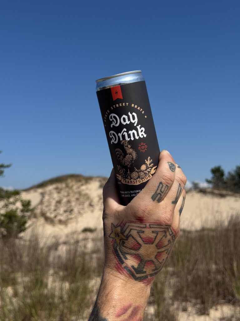 A Day Drink resting in the sand on a sunny day in the dunes.